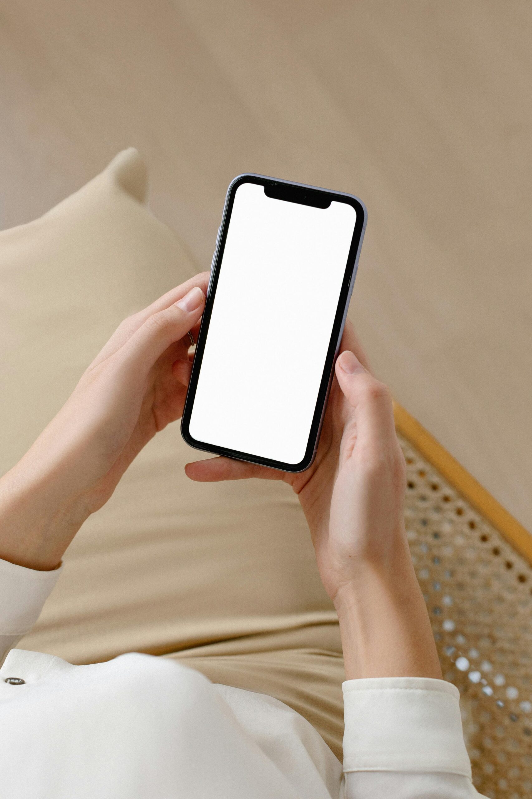 Woman holding smartphone with blank screen for mockup or design purposes, ideal for advertising.